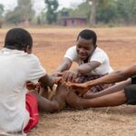 african-children-with-football-ball-sitting